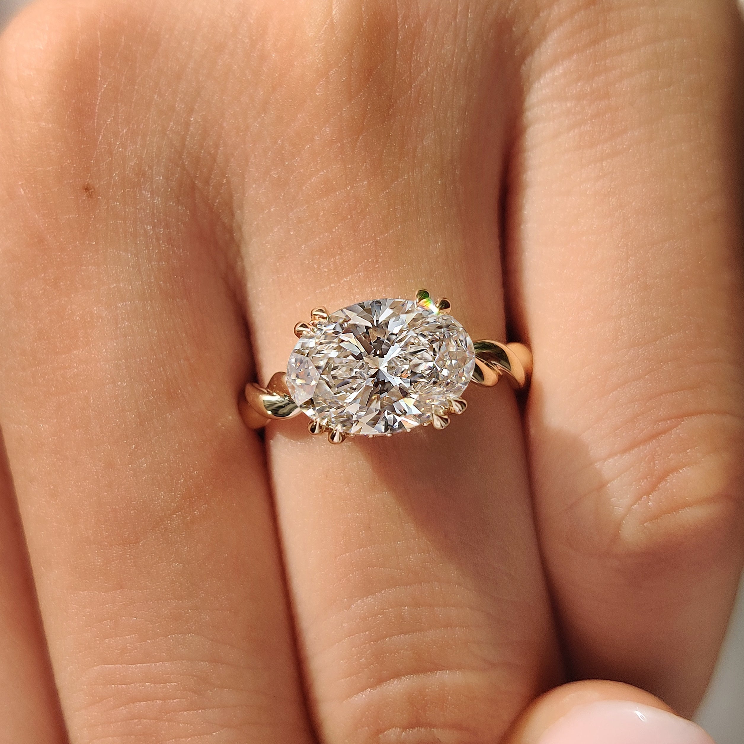 Oval cut diamond ring with east west solitaire setting
