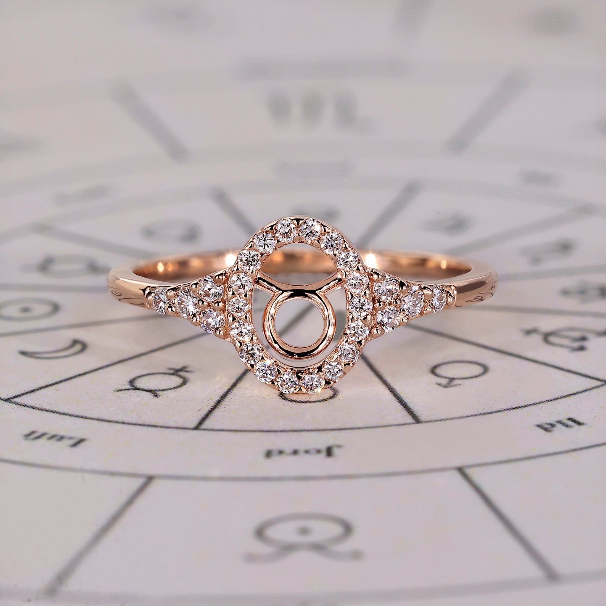Taurus ring in rose gold with halo engagement and round cut diamonds.