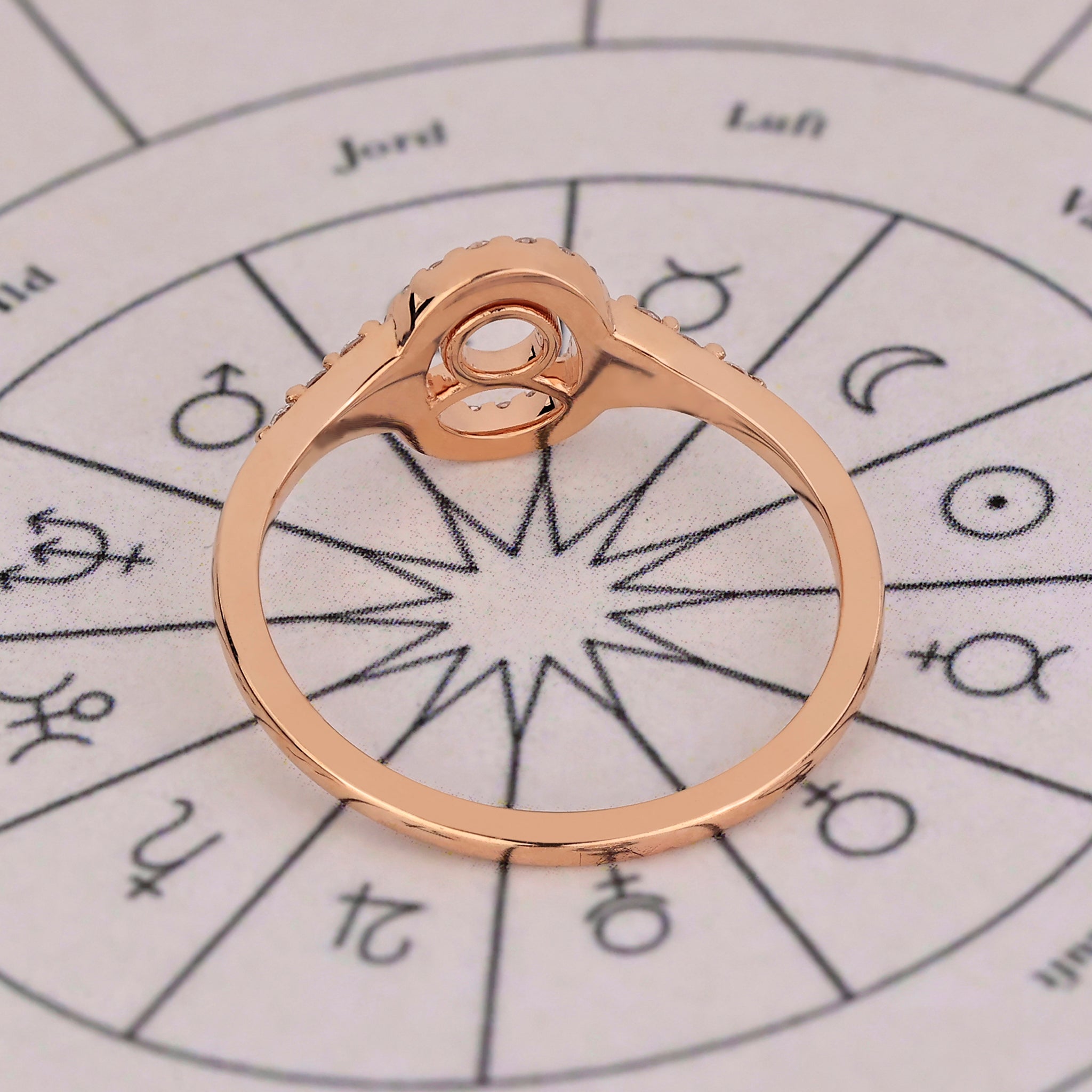 Carat Diamonds Taurus ring with halo diamond design in rose gold.
