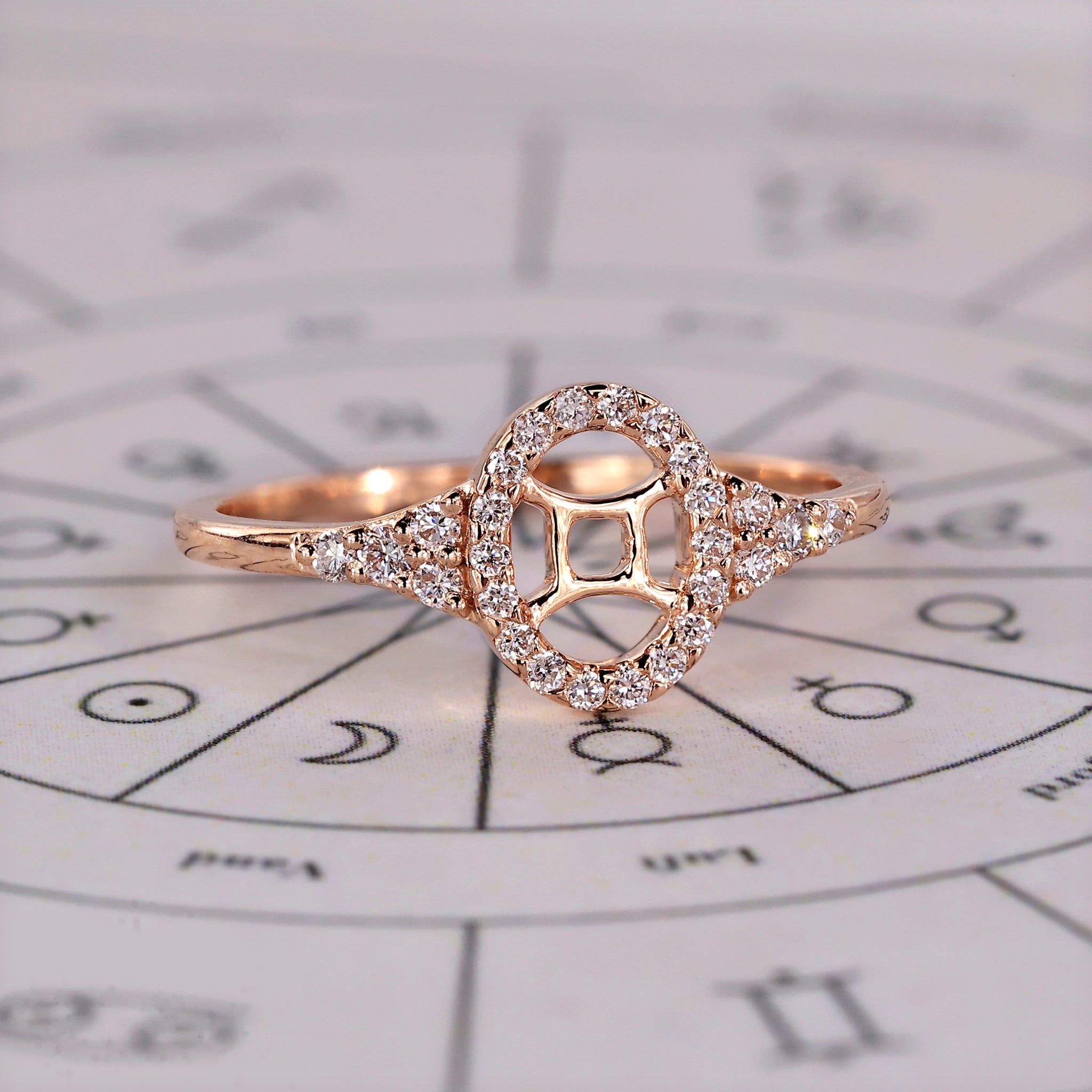 Halo diamond engagement ring in rose gold with Gemini constellation design.
