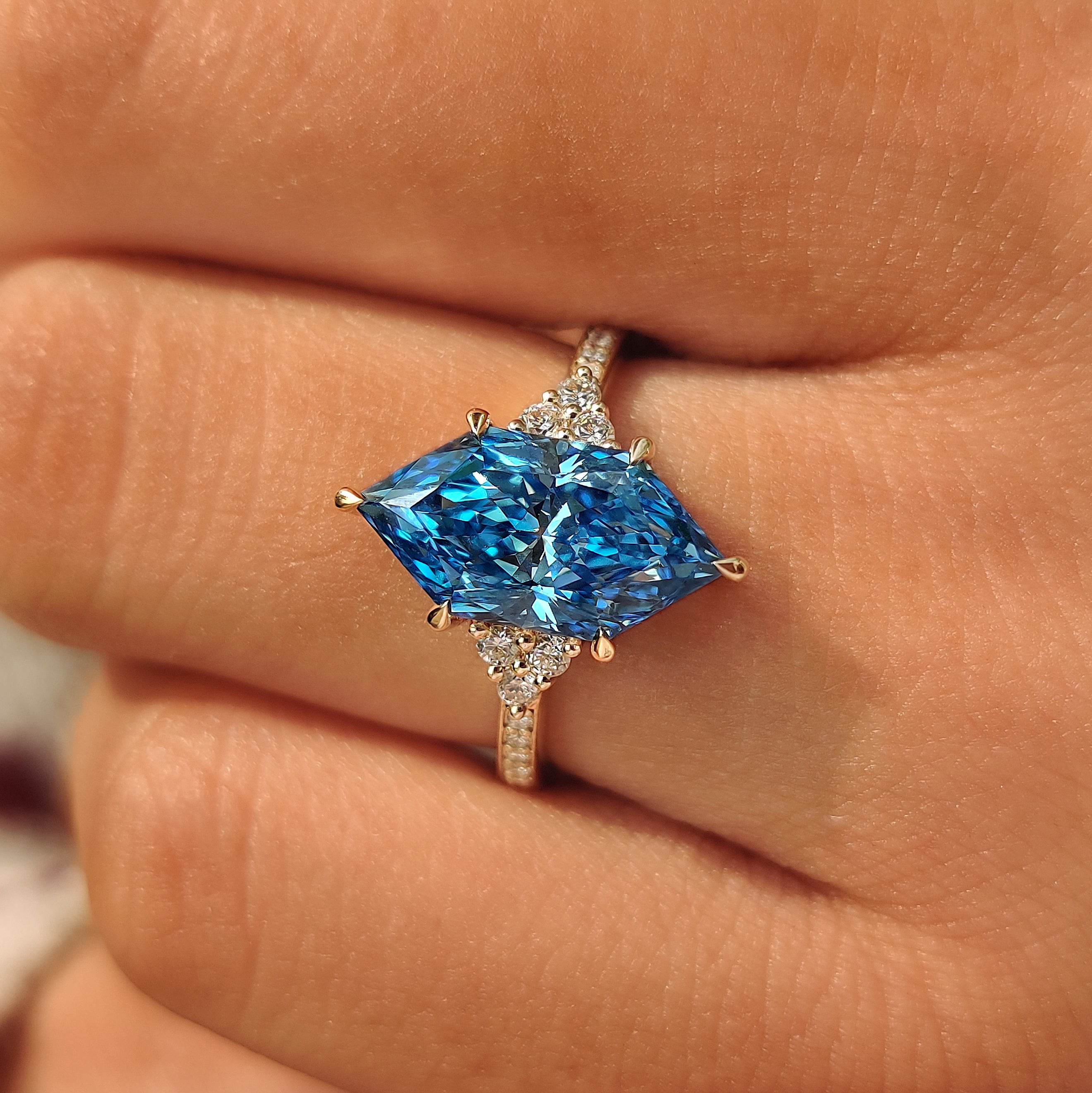 Blue Dutch marquise center diamond with round side stones.
