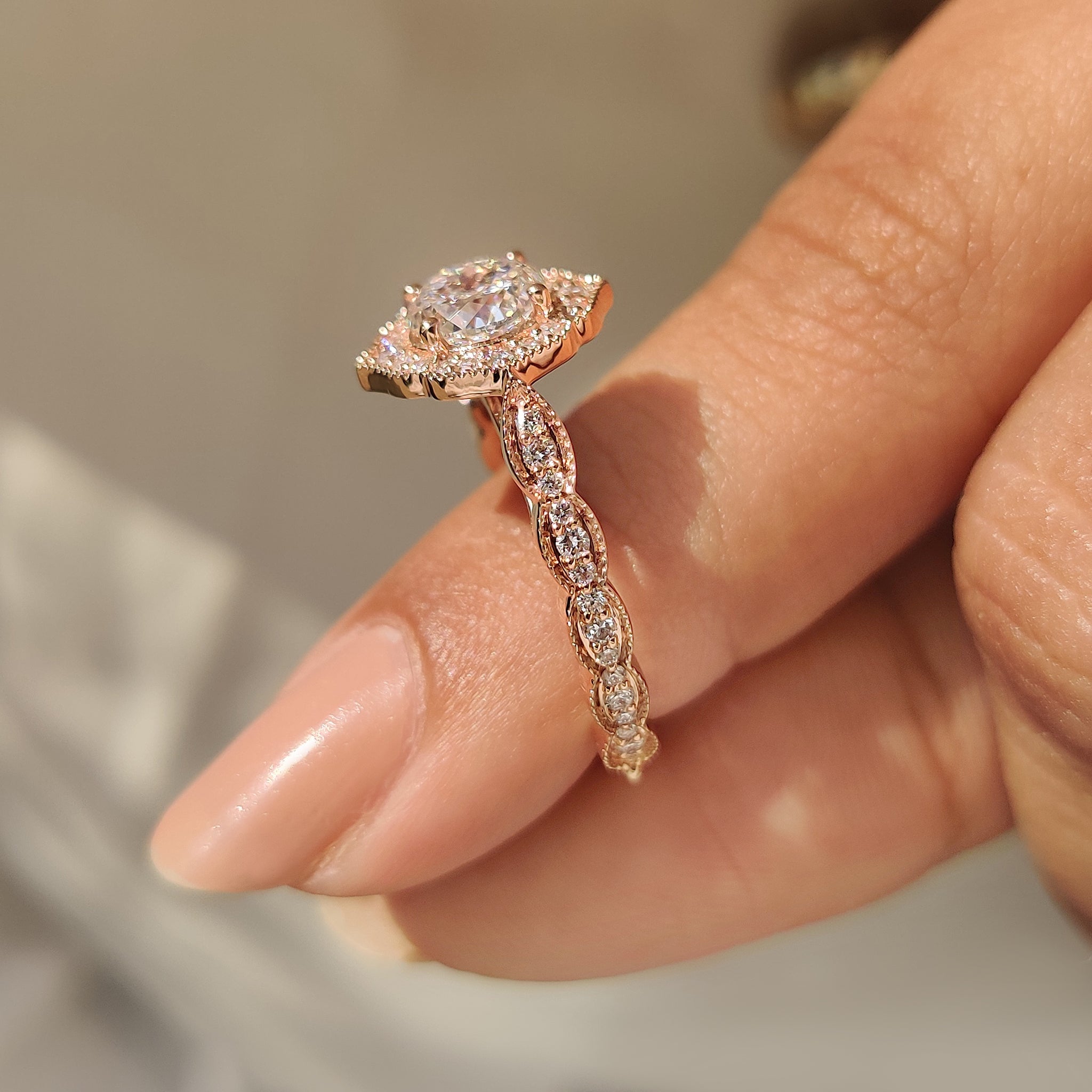Portuguese cut diamond ring with cathedral setting and halo.
