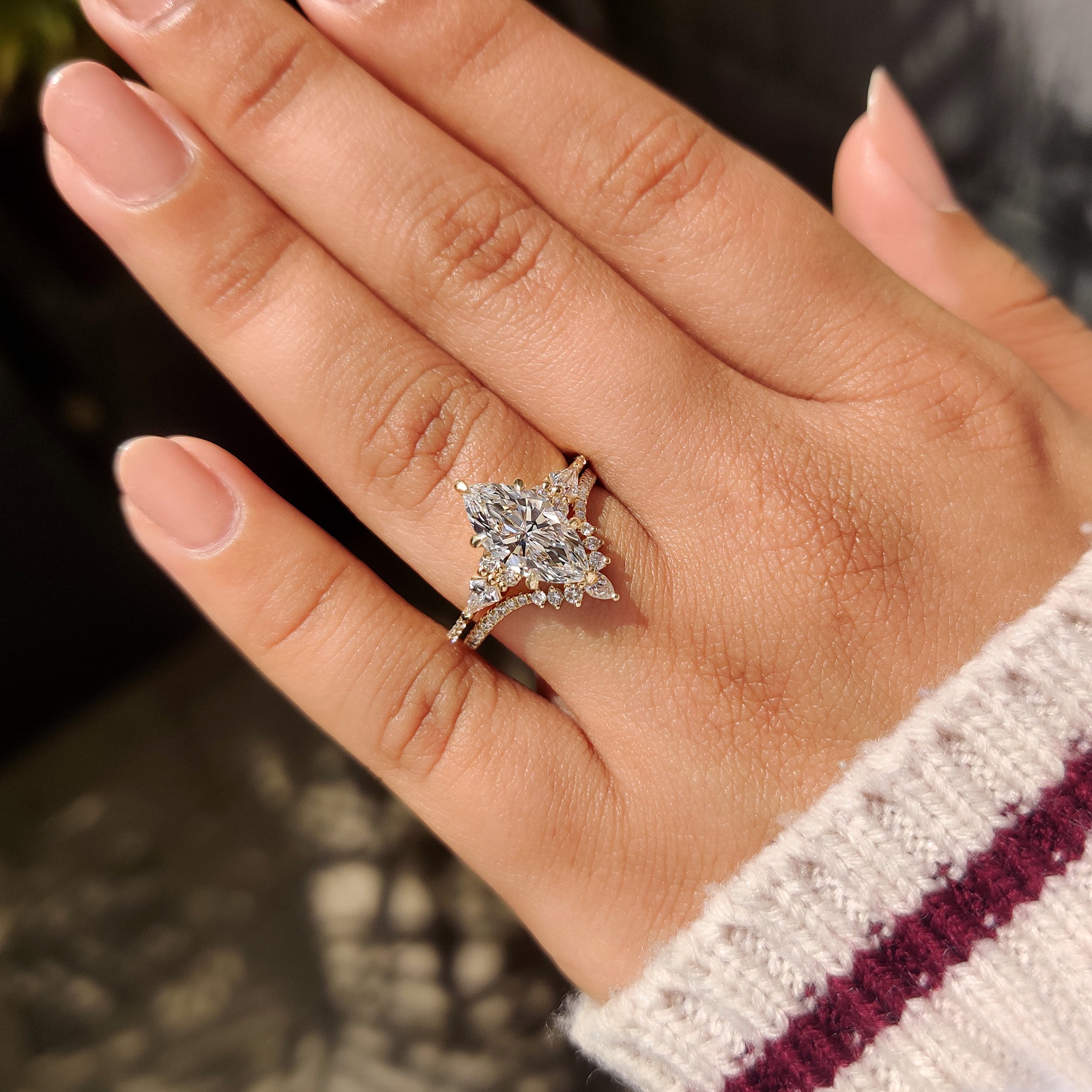 Marquise ring set with kite stones and tapered shank.
