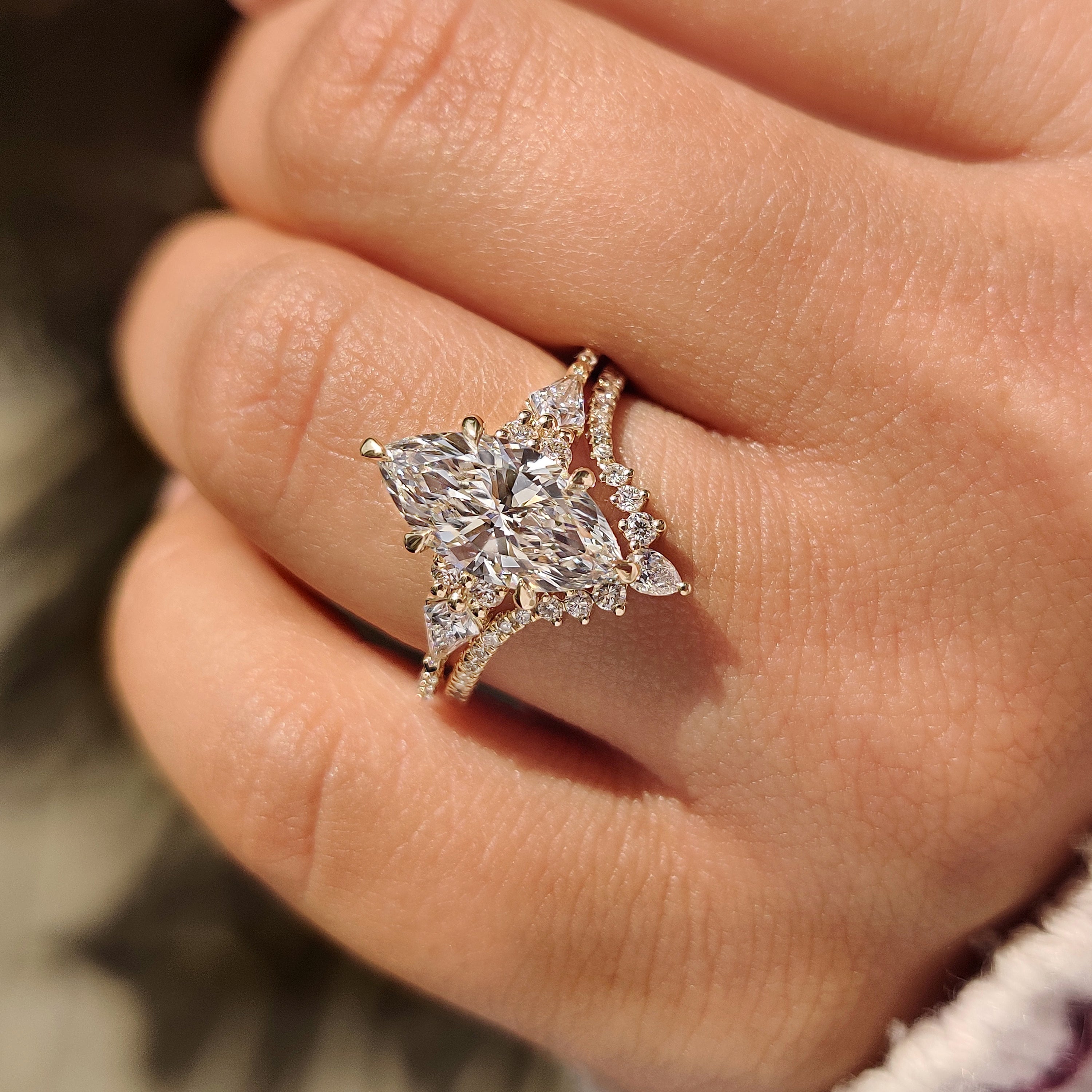 Marquise diamond ring with kite side stones and pave.
