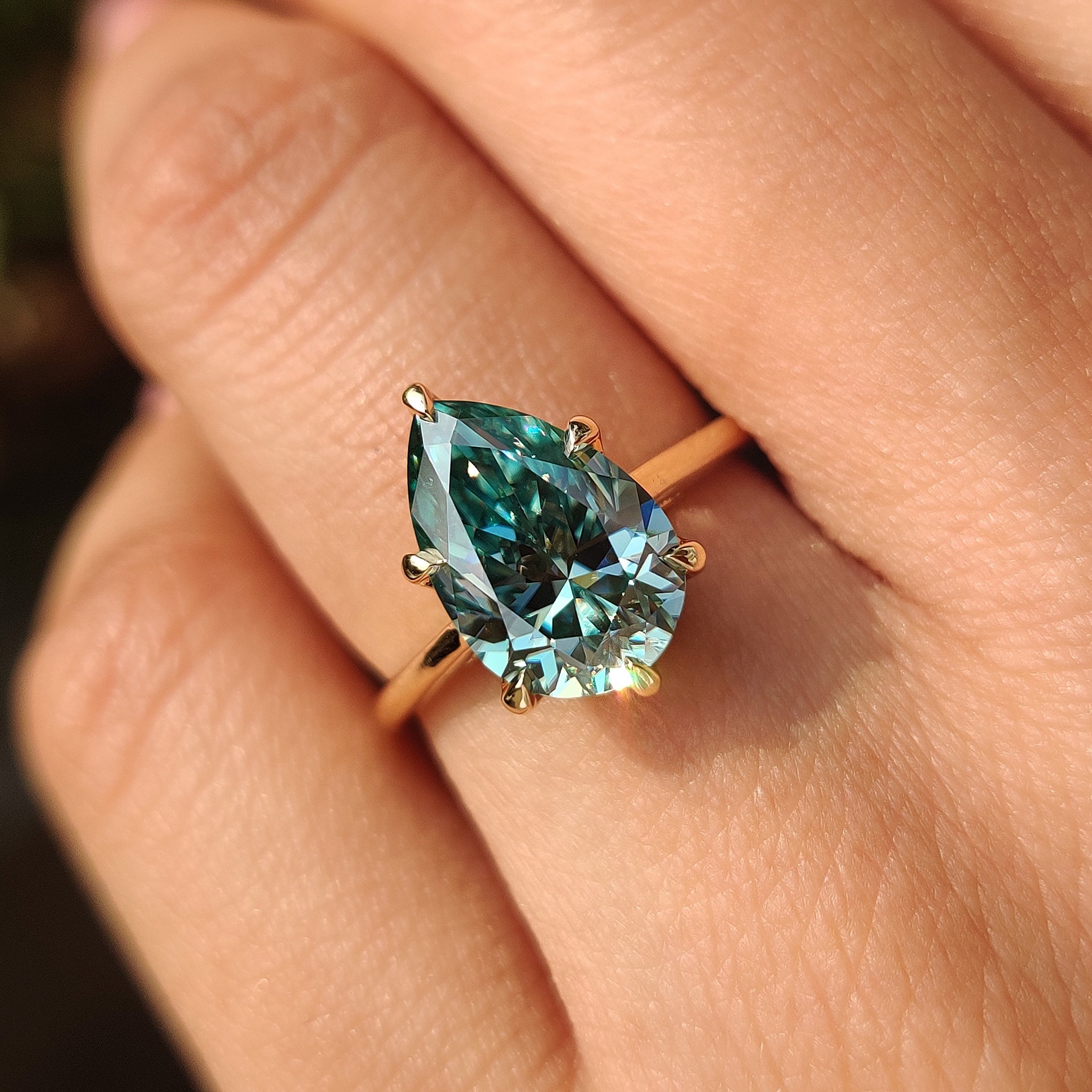 Pear solitaire moissanite ring tulip basket.
