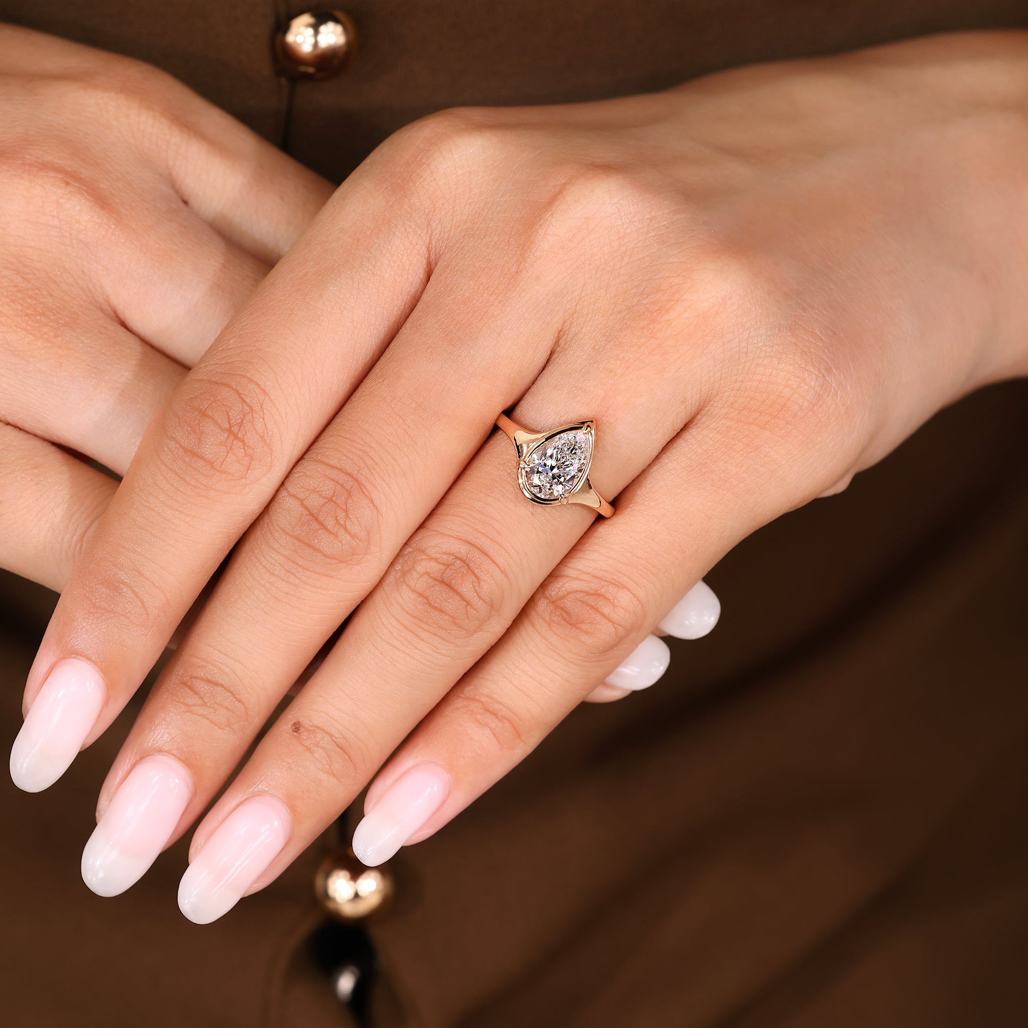Pear cut diamond ring with three claw prong setting.

