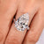 Handmade pear diamond ring with round double row pave and elegant bypass shank.
