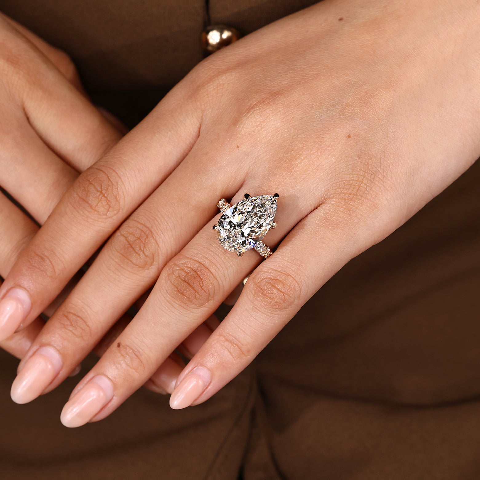 Marquise and round pave around pear cut center diamond
