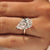 Yellow gold engagement ring with a 5 carat pear cut diamond.
