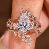 Pear shaped engagement ring with nature inspired wedding band
