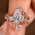 Pear shaped engagement ring with nature inspired wedding band
