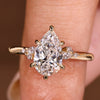Pear cut engagement ring with marquise and round accents
