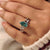 Cyan blue pear moissanite ring with floral five claw