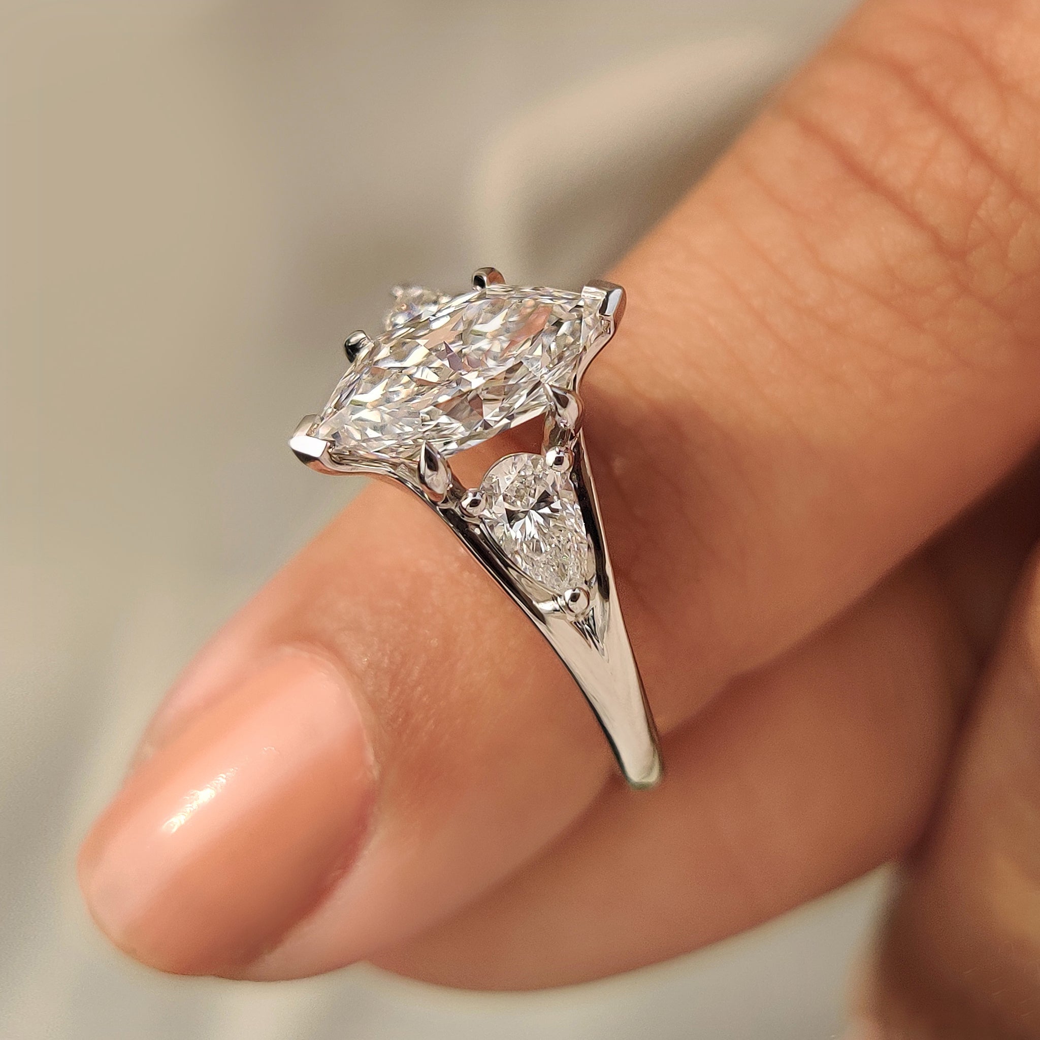 Dutch marquise lab diamond ring with three stone setting.
