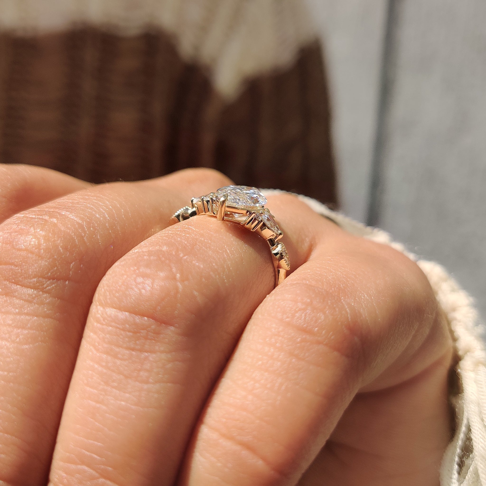 Marquise cut ring with two claw prong and side stones.
