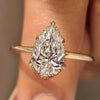Pear diamond ring with nature inspired leaf prongs.