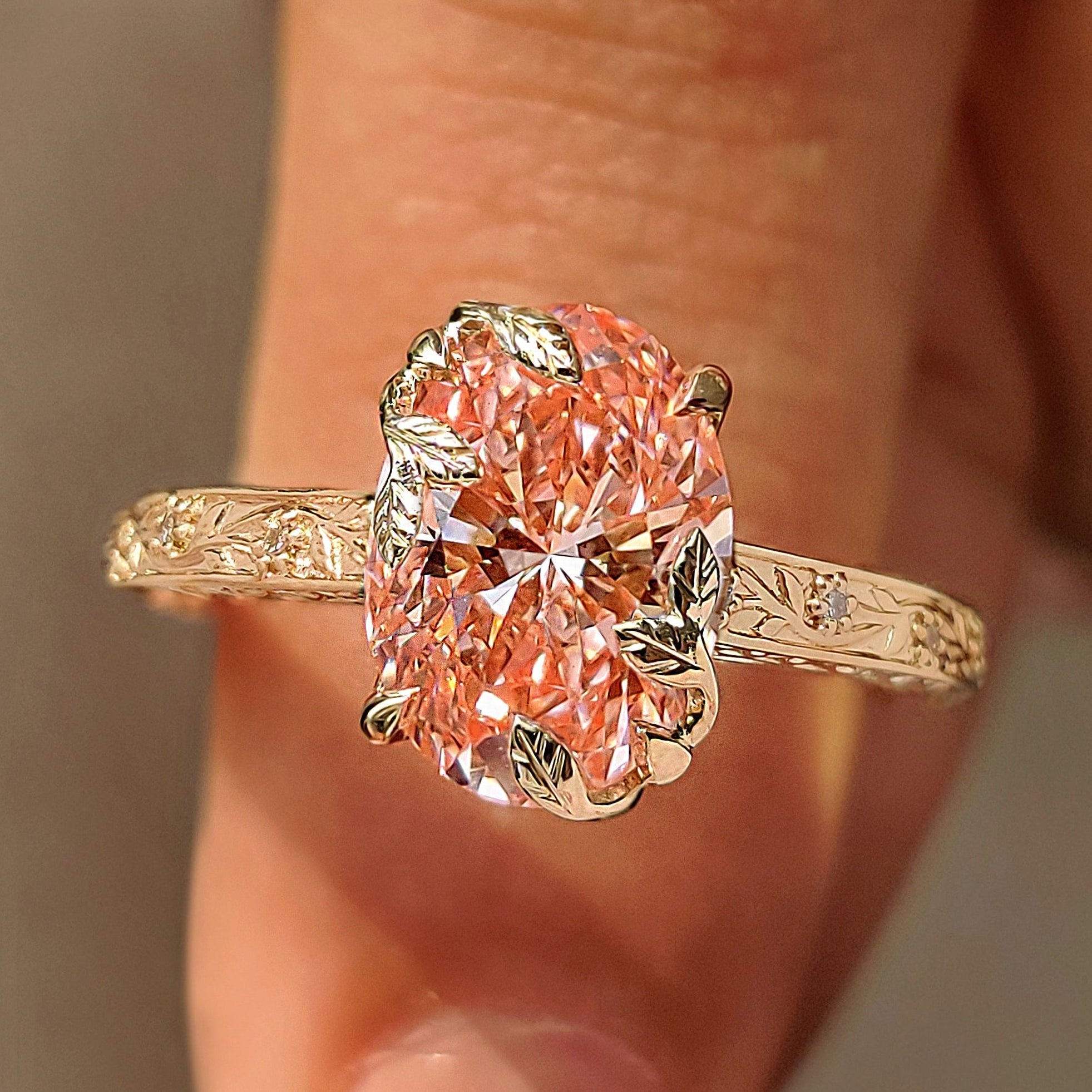 Pink oval diamond ring with round diamond accents.