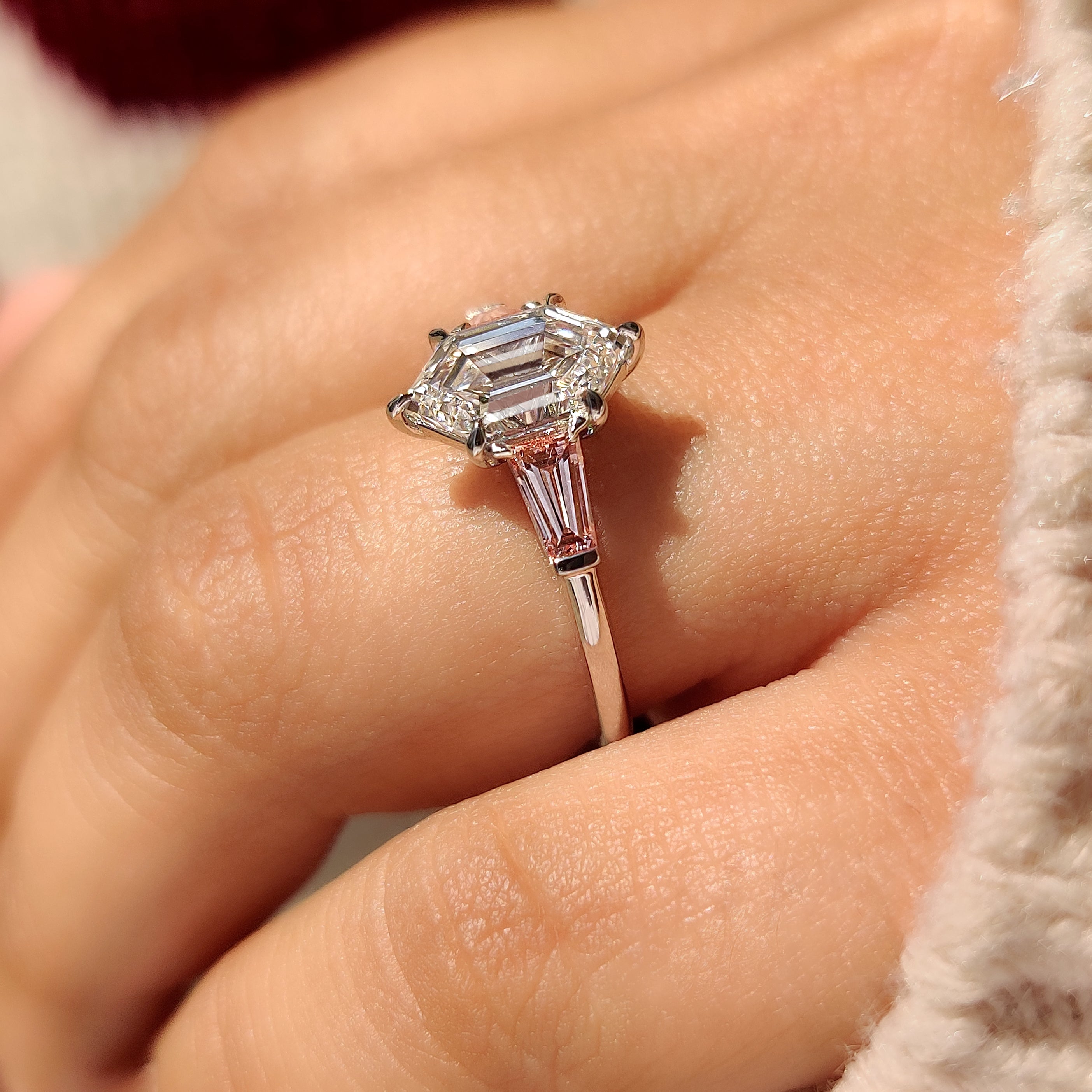 Three stone engagement ring with tapered baguette side stones
