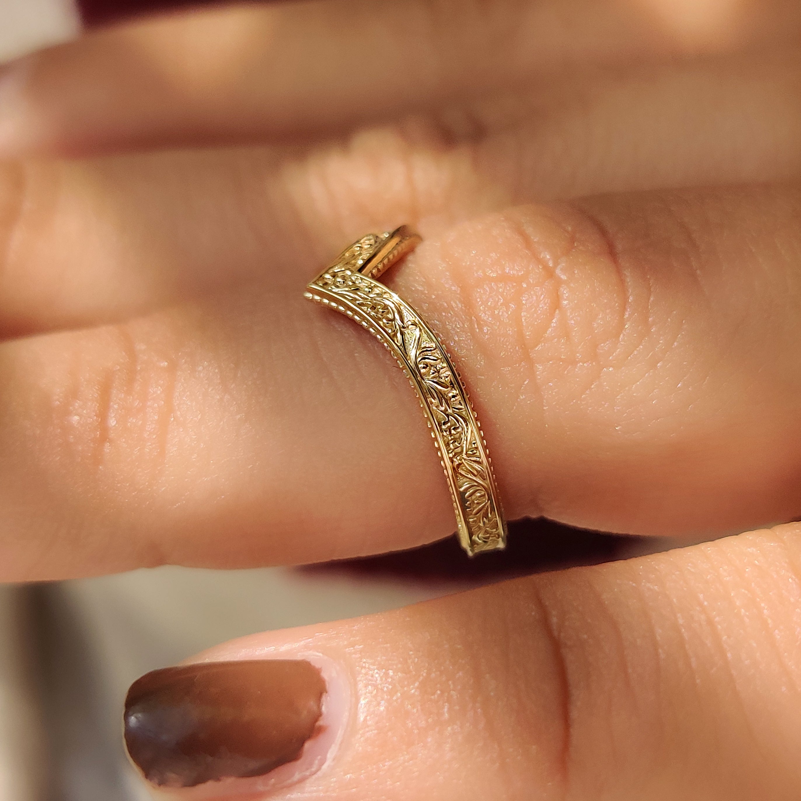 V shape wedding band with detailed milgrain edge pattern
