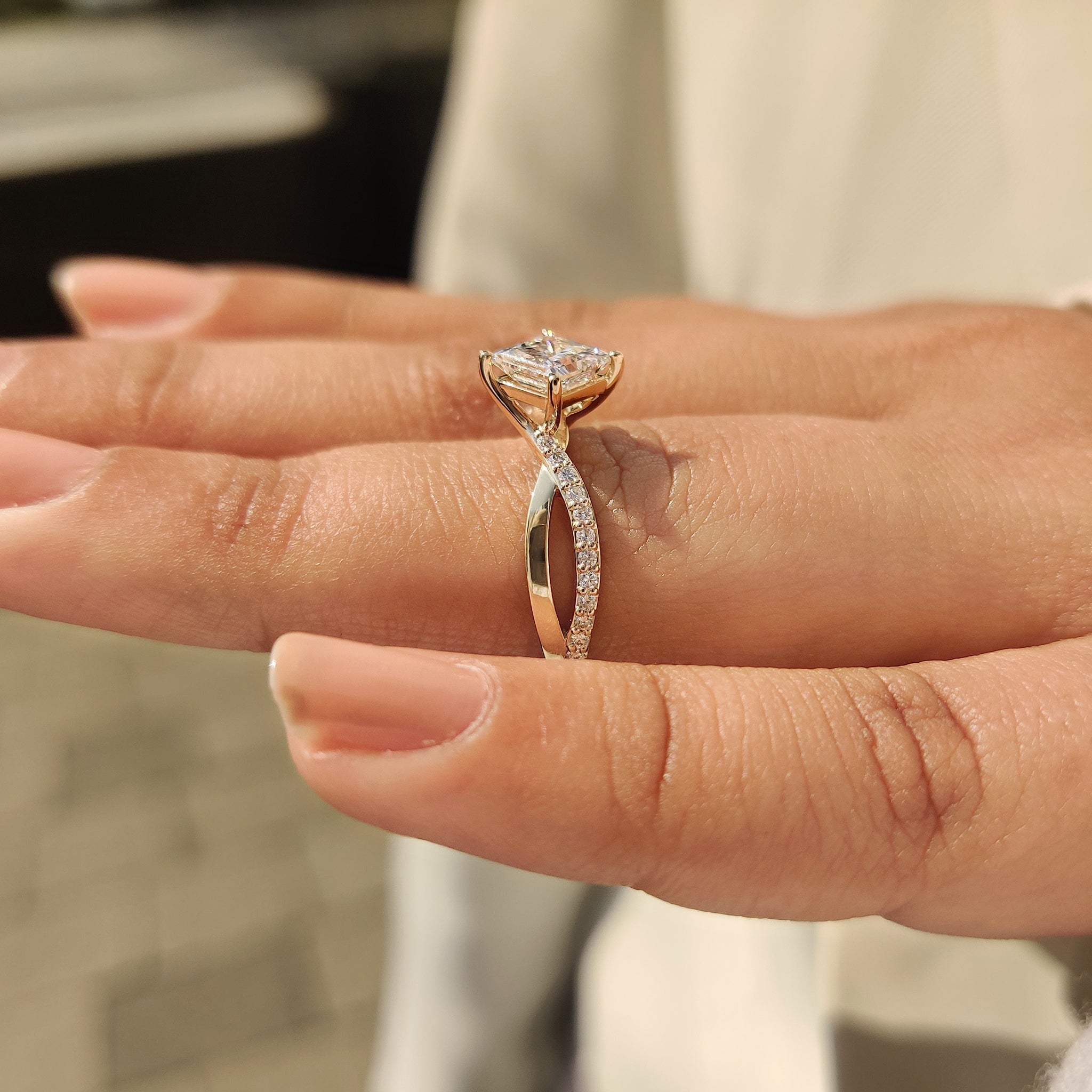 Princess cut diamond ring featuring twisted pave band
