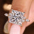 Princess cut diamond ring with marquise and round side stones.

