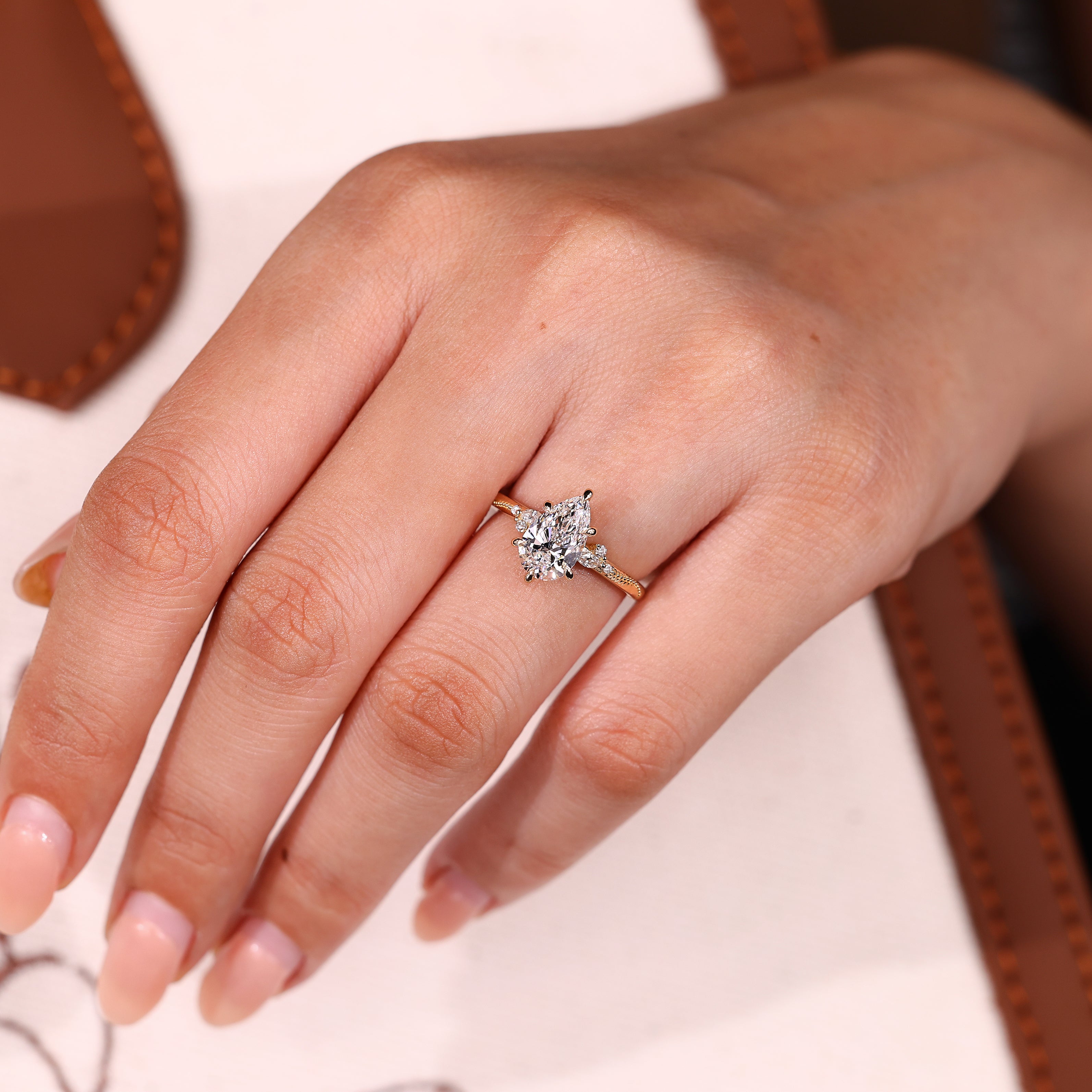 Pear cut lab diamond ring with side stone accents
