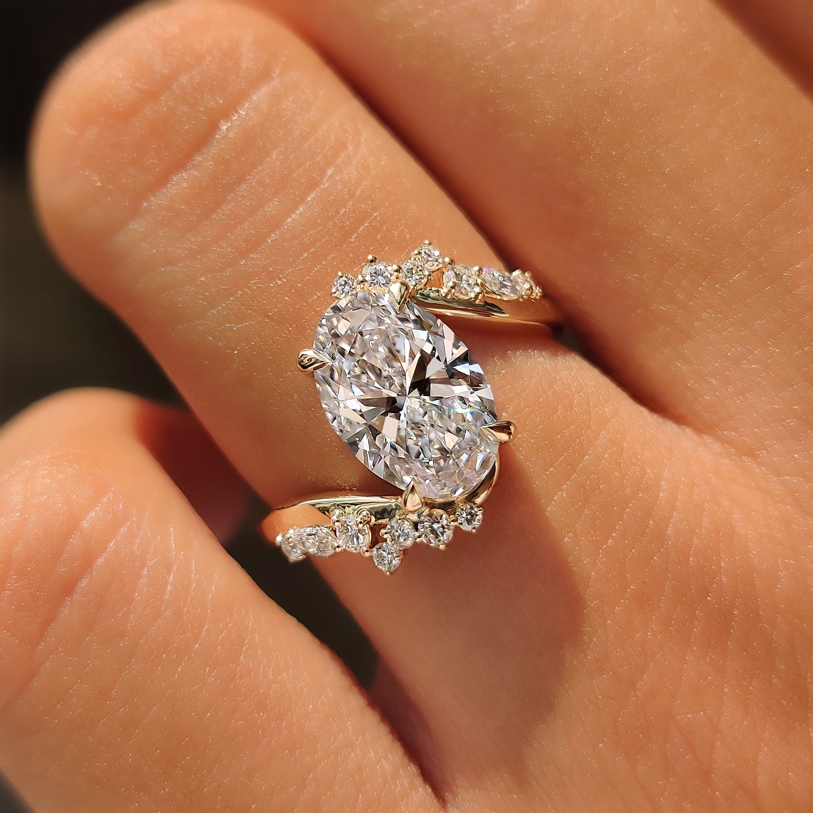 Handmade yellow gold ring with an oval cut center diamond.
