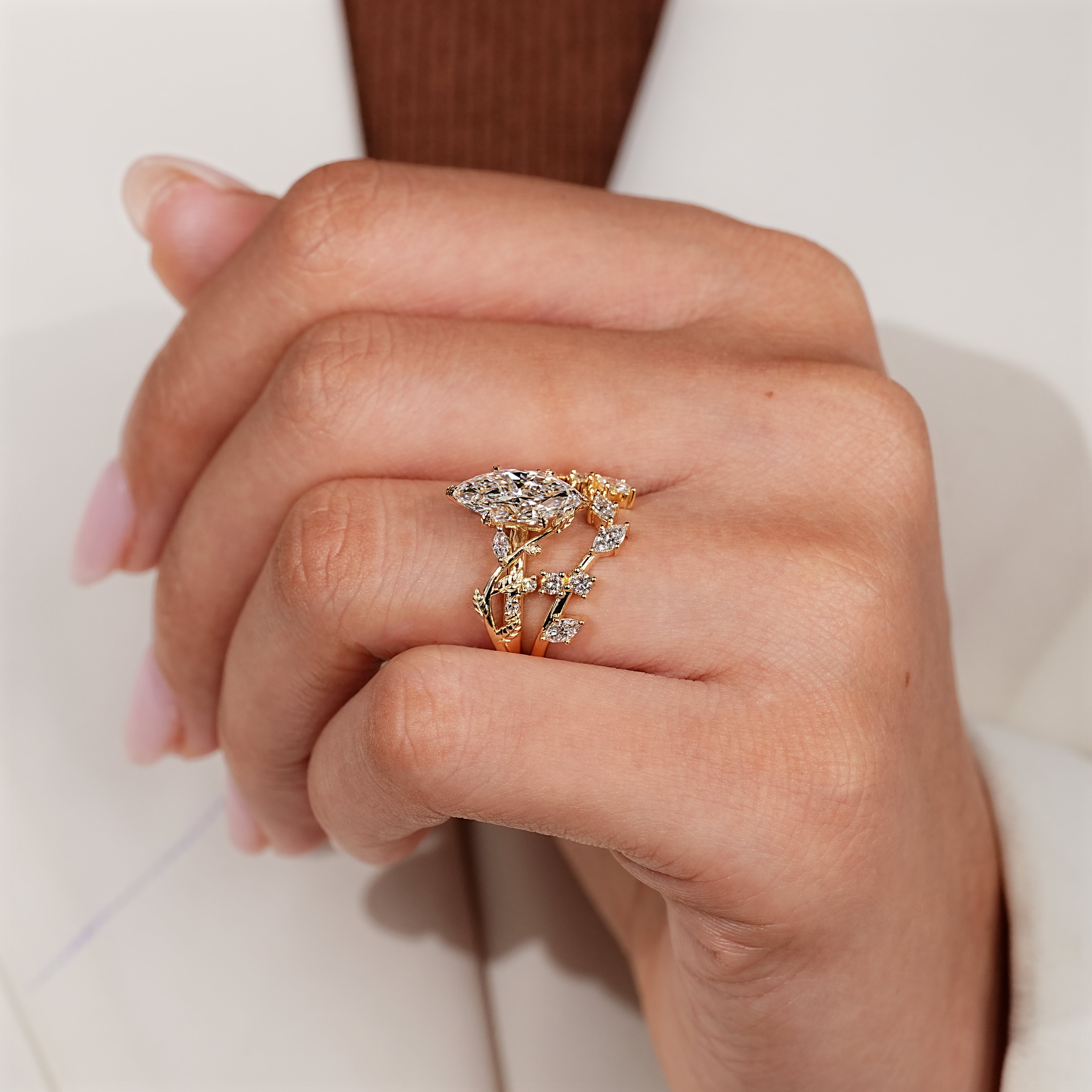 Marquise and round side stones on a bridal set.
