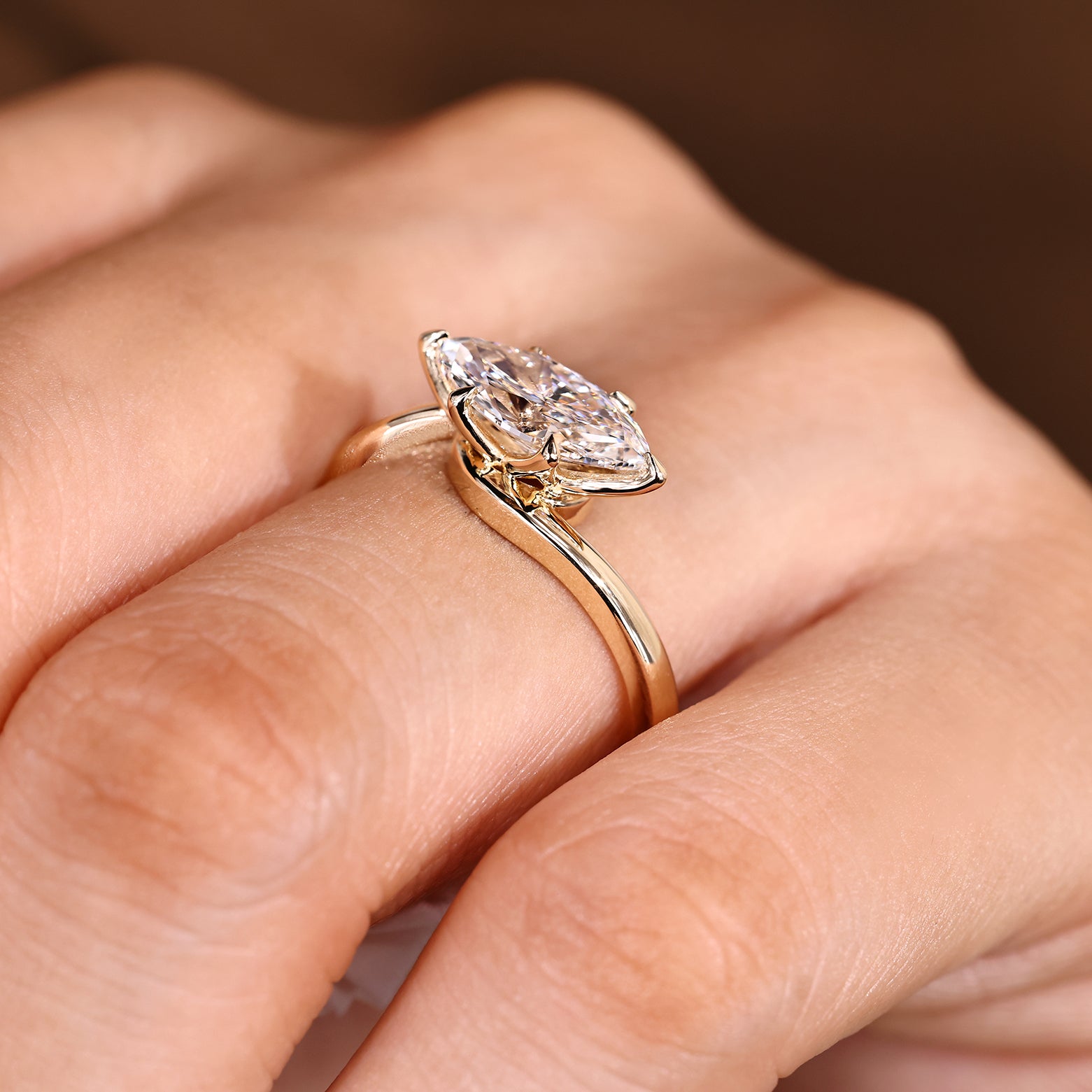 Marquise engagement ring with lab grown diamond center
