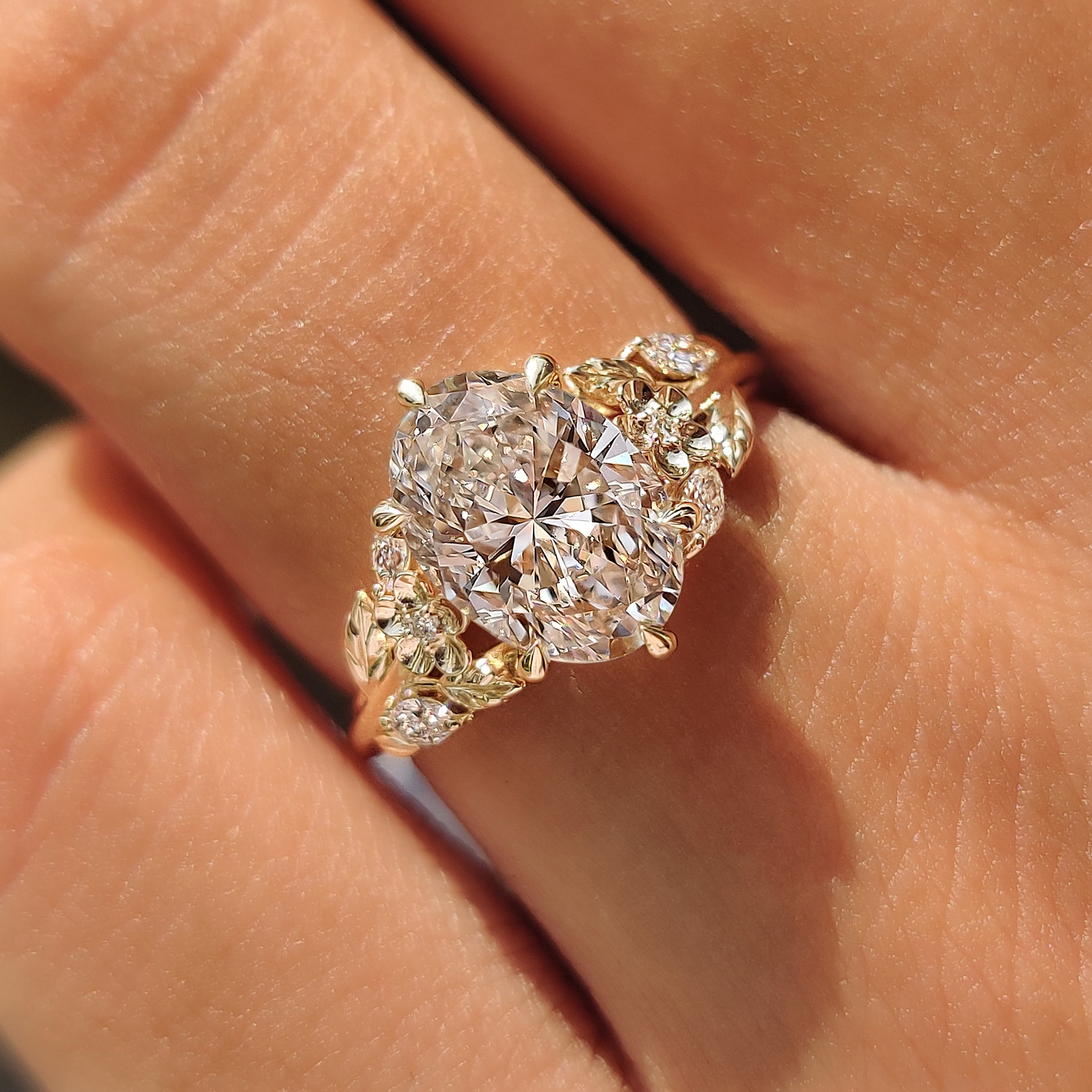 Cherry blossom flower details on a yellow gold ring.
