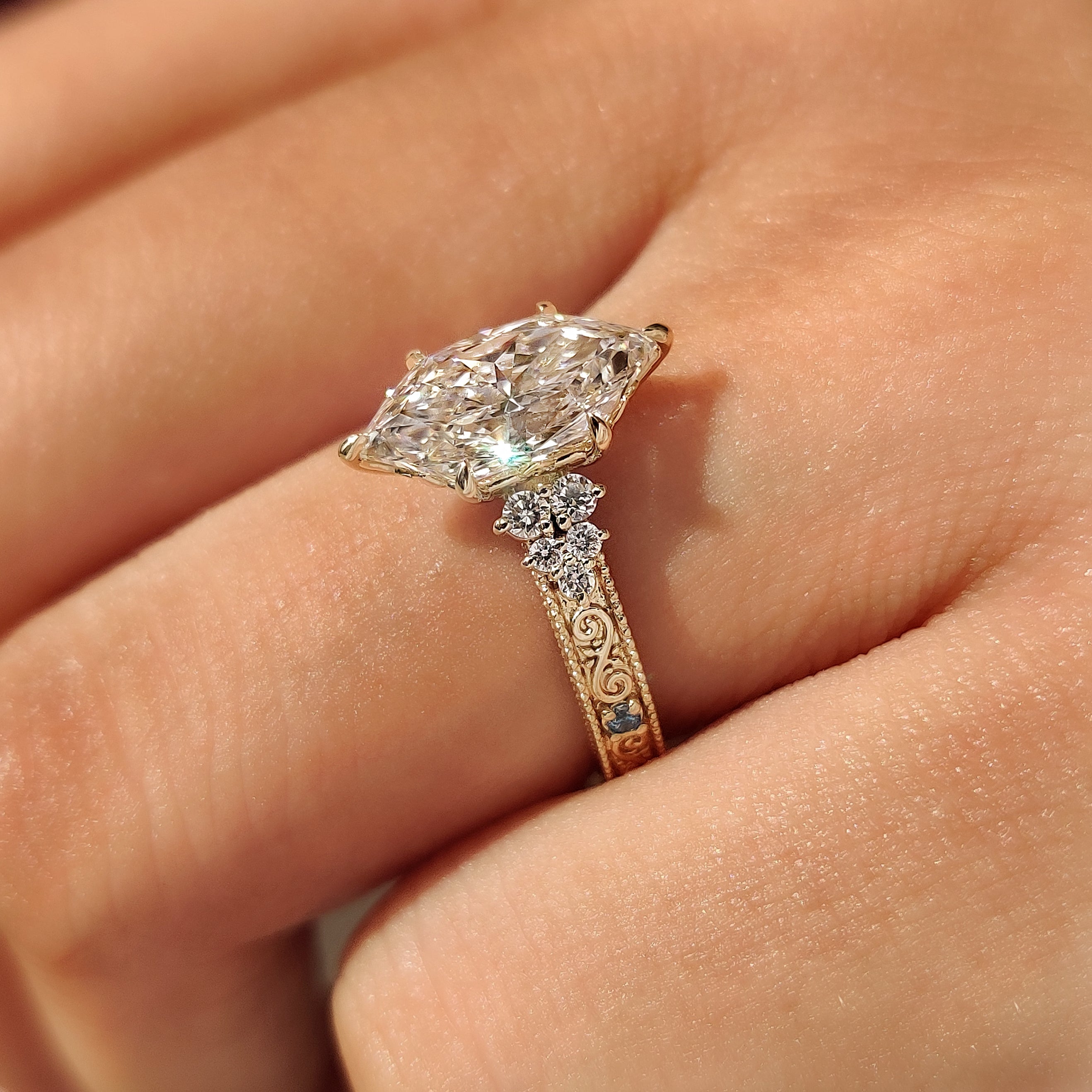 Dutch marquise center diamond with round aquamarine side stones
