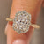 Radiant cut ring with round diamond pave band.

