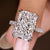 Radiant cut diamond ring with round diamond pave band
