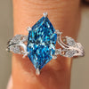 Nature inspired blue Dutch marquise ring with marquise and round side stones.
