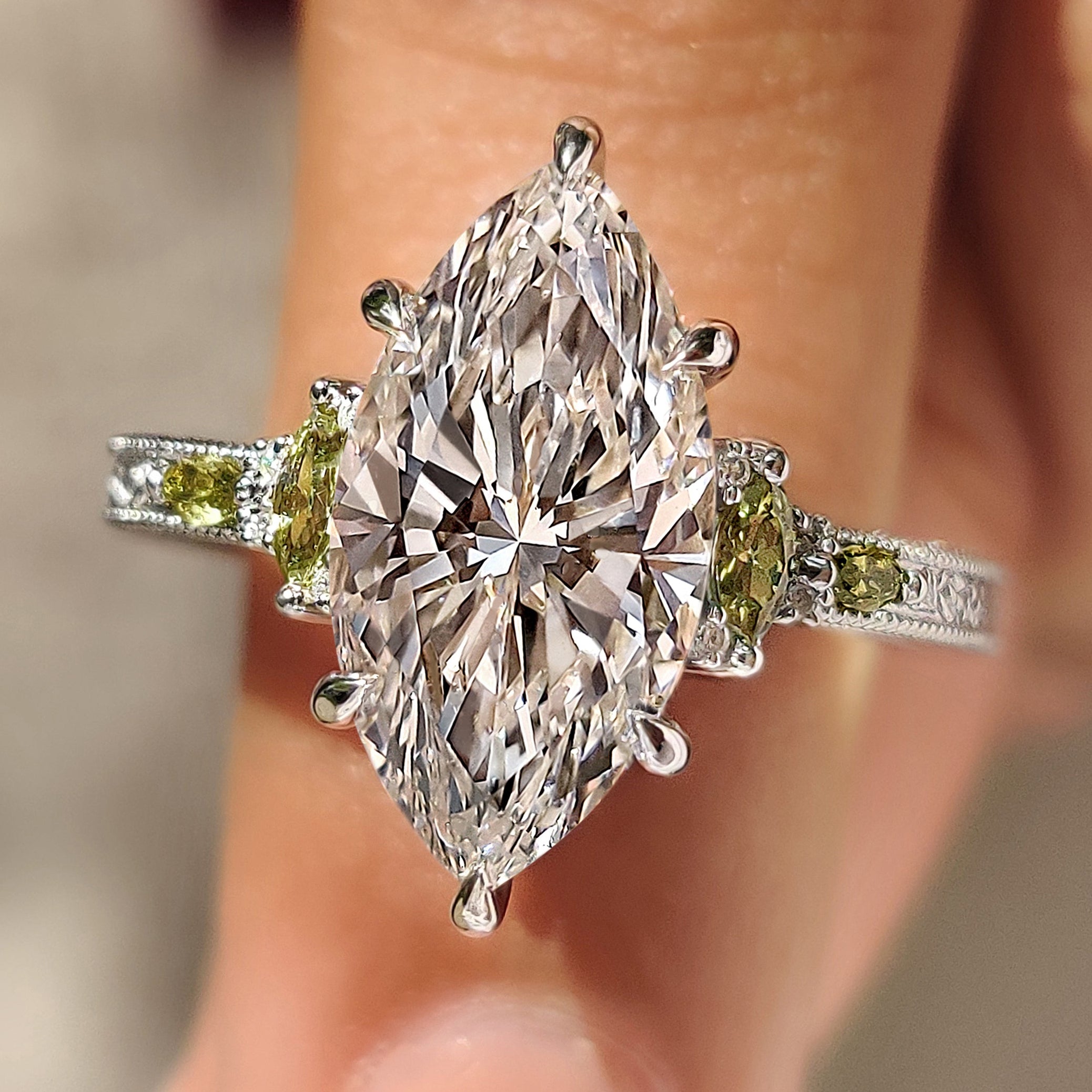 Marquise engagement ring with peridot side stones and milgrain
