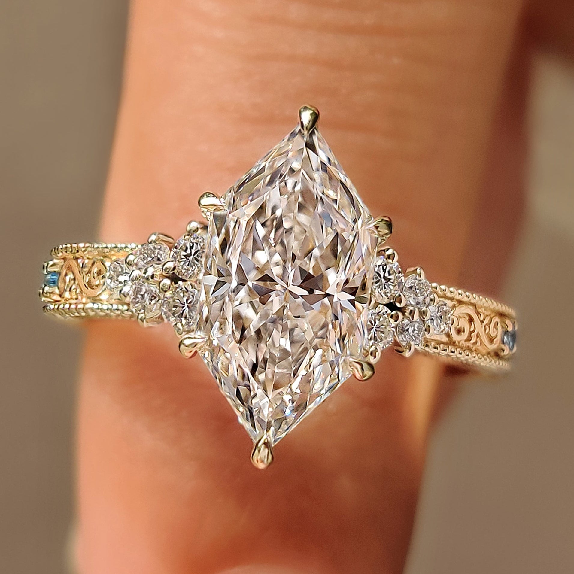 Dutch marquise engagement ring with round aquamarine side stones
