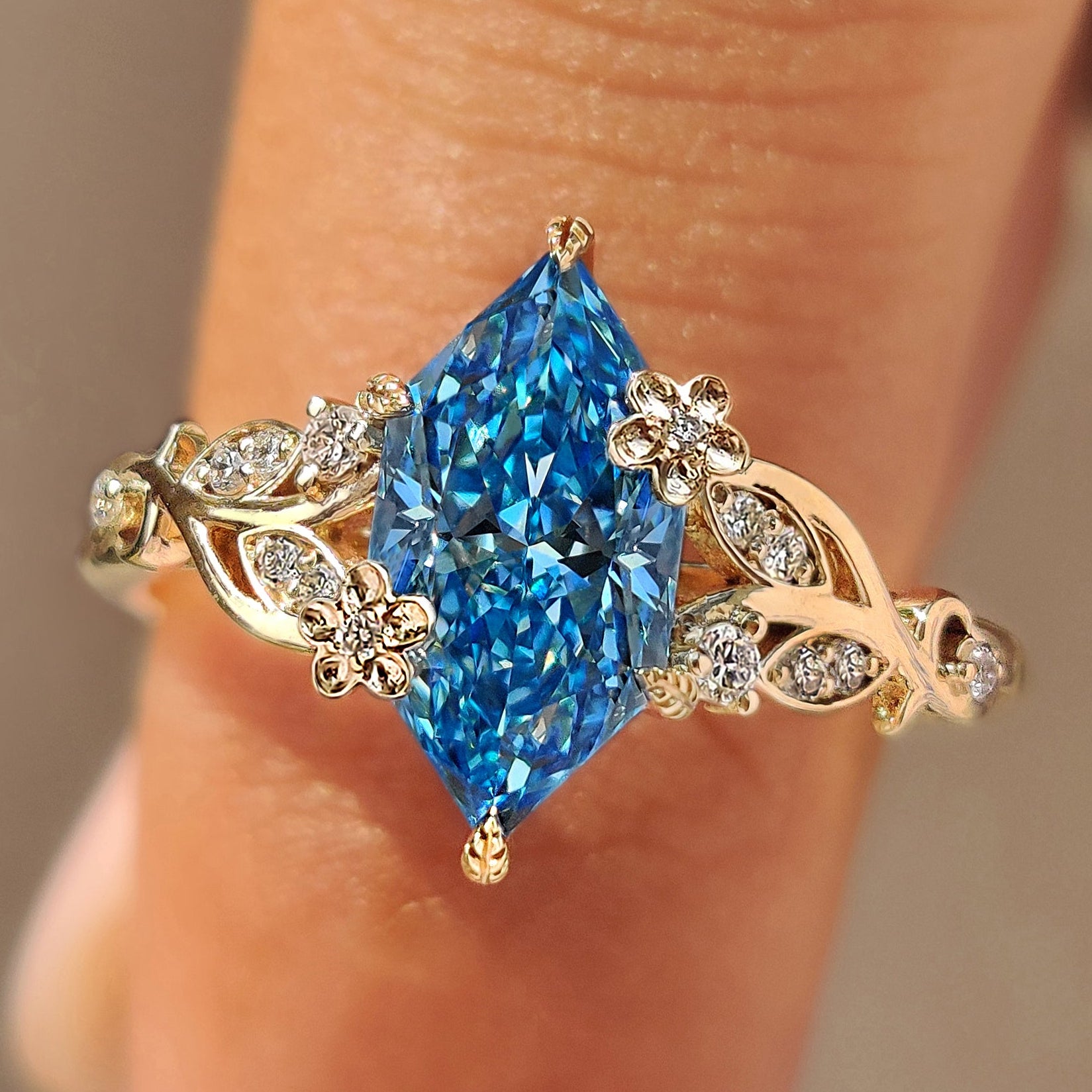 Blue Dutch marquise engagement ring with round side stones.
