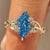 Blue Dutch marquise engagement ring with round side stones.
