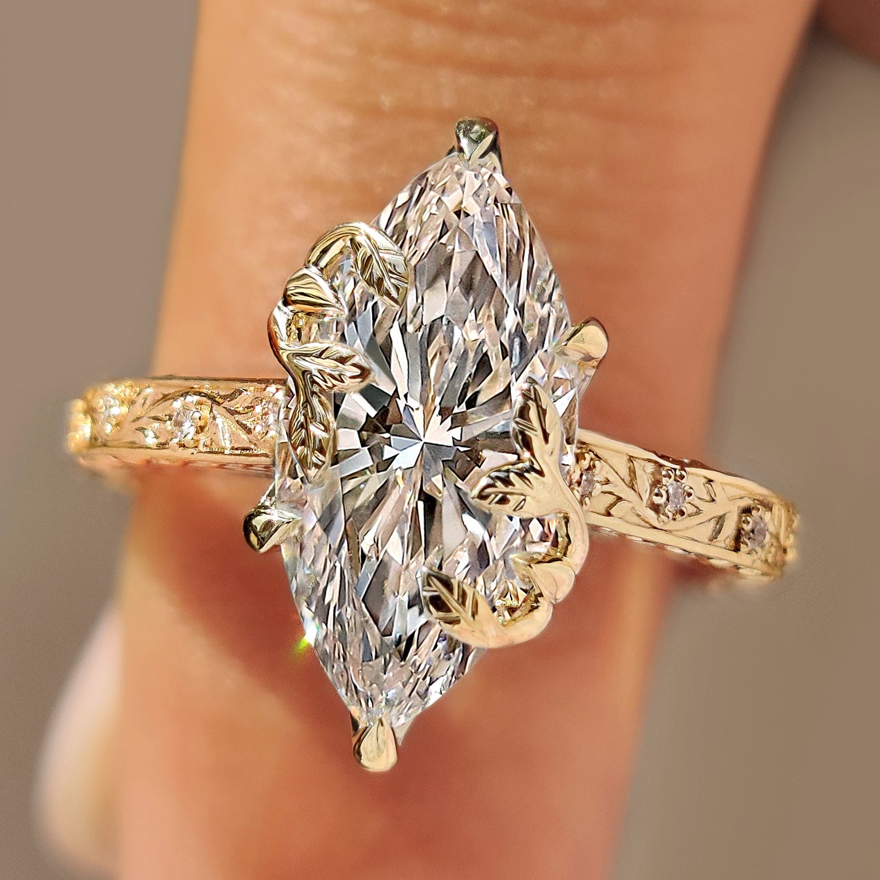 Marquise diamond engagement ring with round diamond accents.
