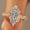 Marquise diamond engagement ring with round diamond accents.
