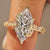 Marquise diamond engagement ring with round diamond accents.
