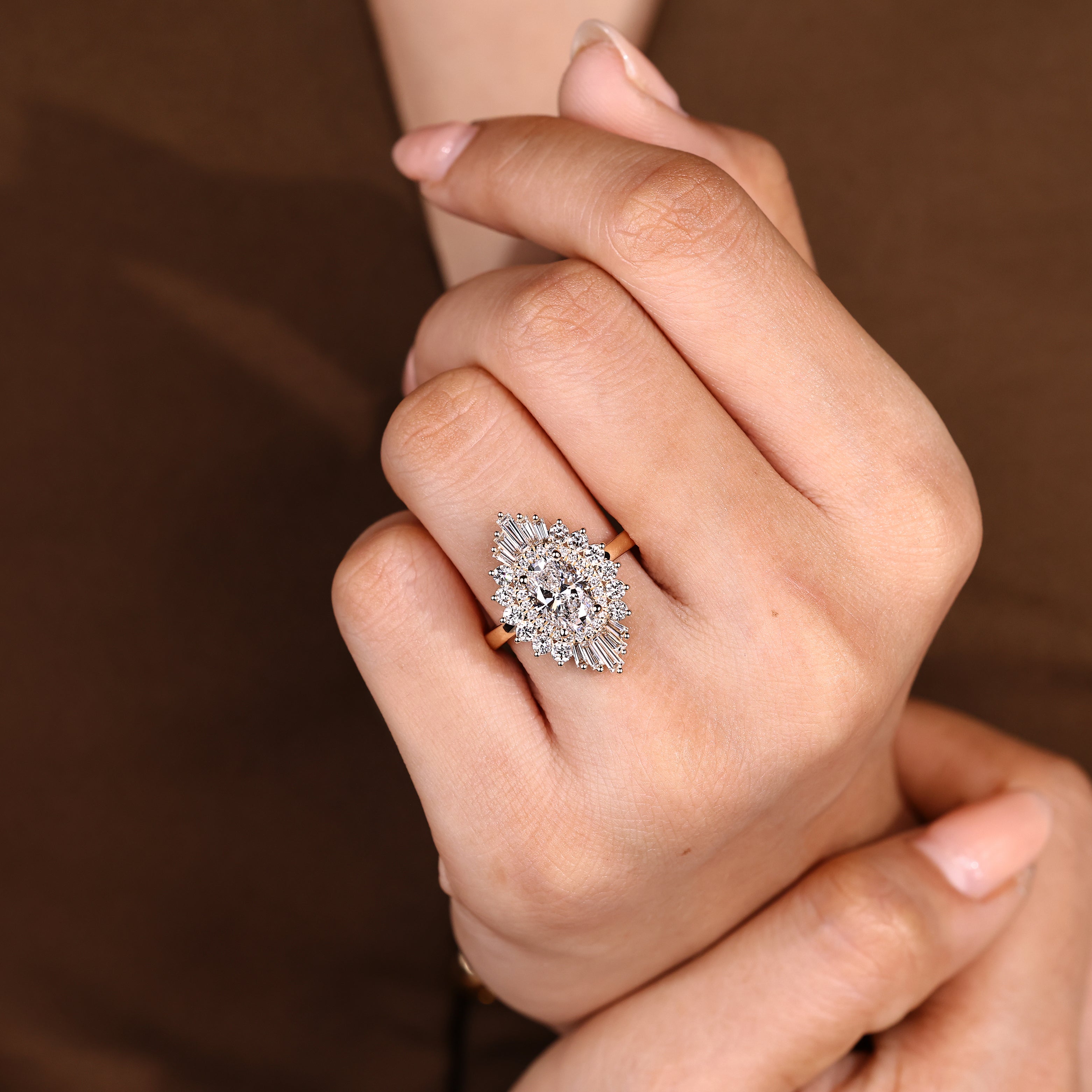 Oval engagement ring with tapered baguettes and four prongs
