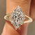 Marquise diamond ring with round side stone details
