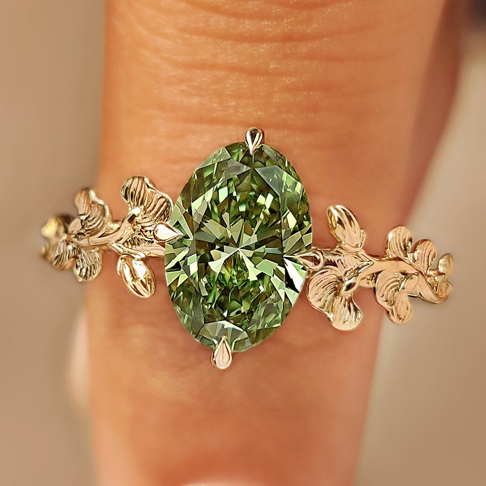 Green oval cut diamond ginkgo leaf ring.
