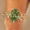 Green oval cut diamond ginkgo leaf ring.
