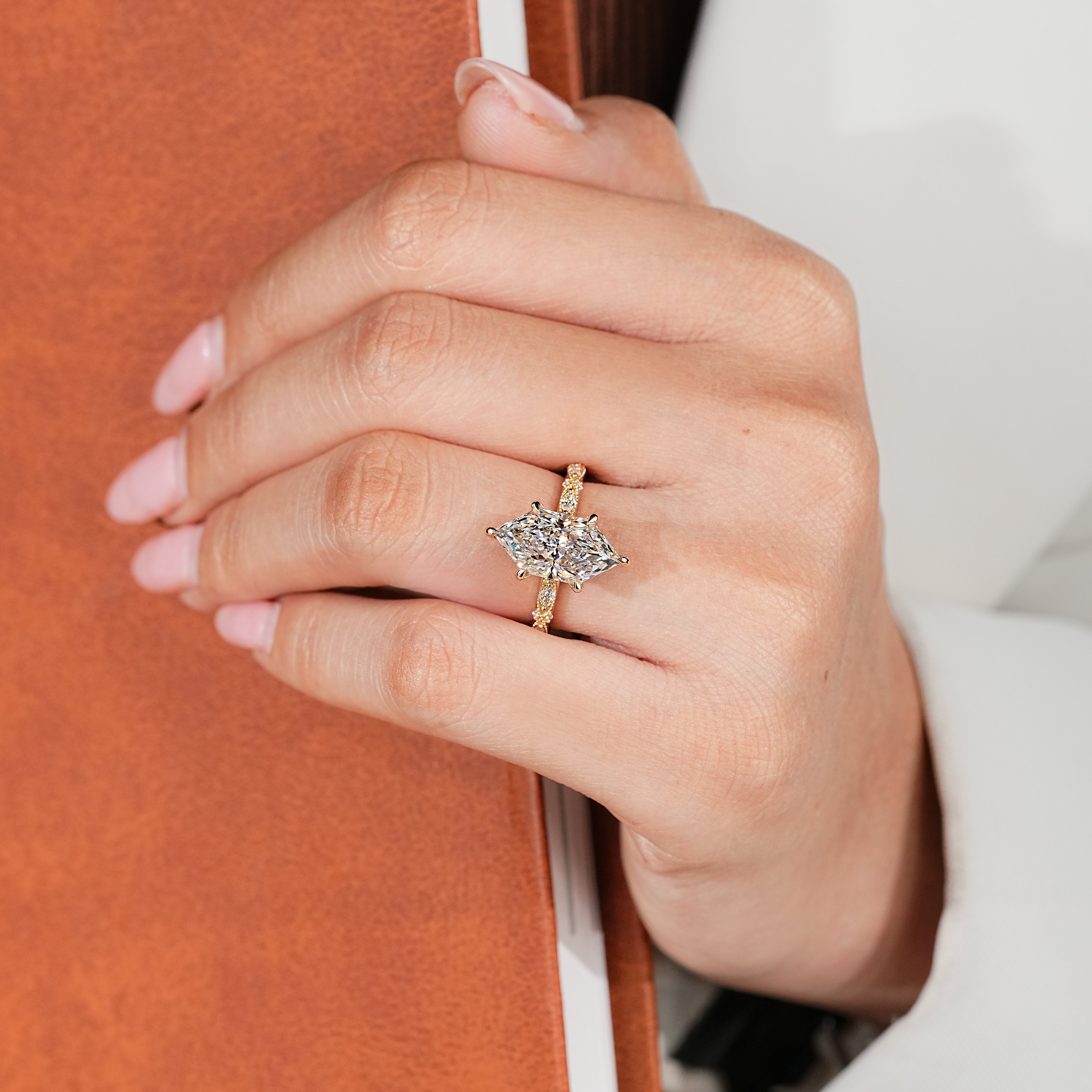 Dutch marquise center diamond with six claw prong setting
