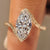 Marquise solitaire ring with vintage inspired bypass setting.
