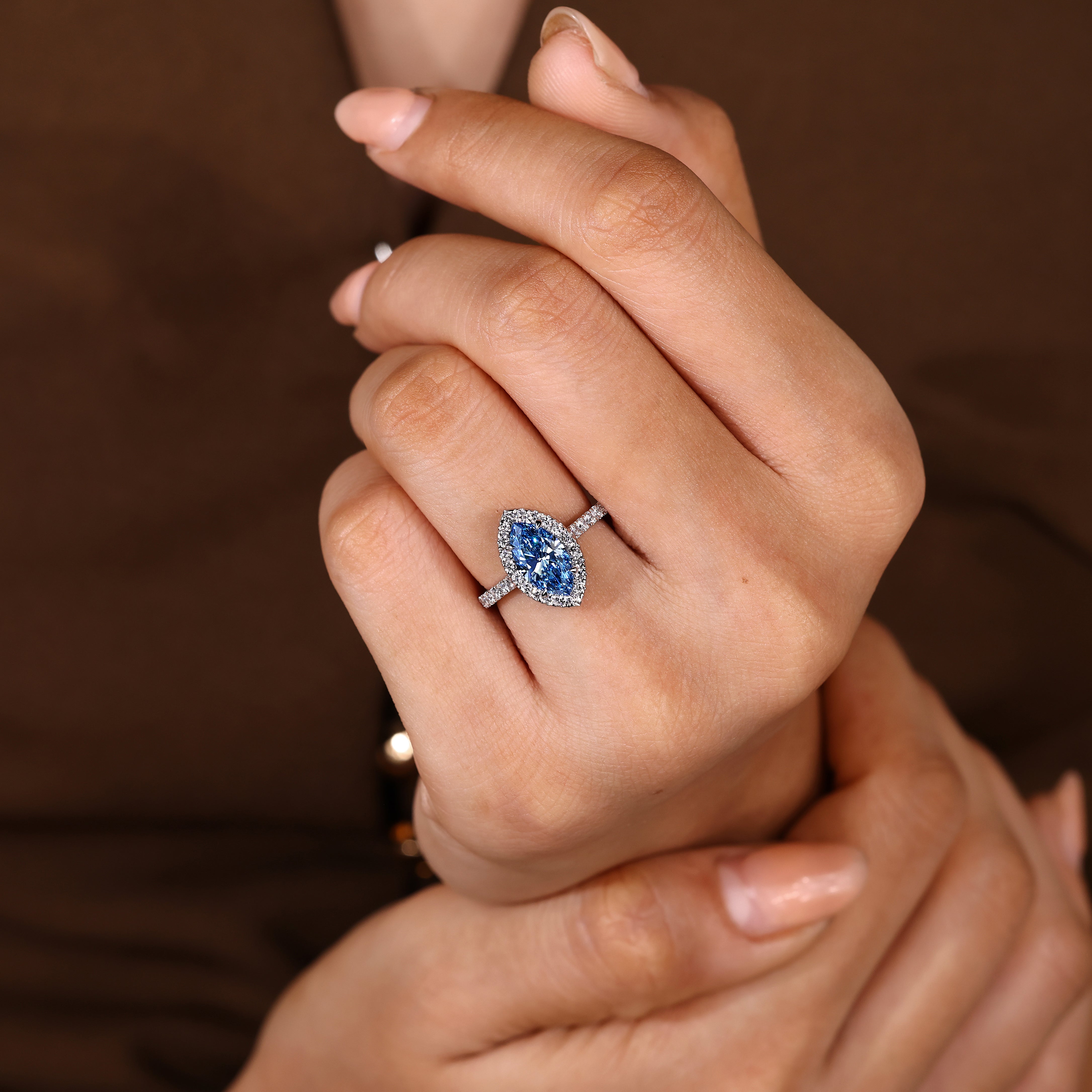 Handmade marquise ring with blue center and halo design
