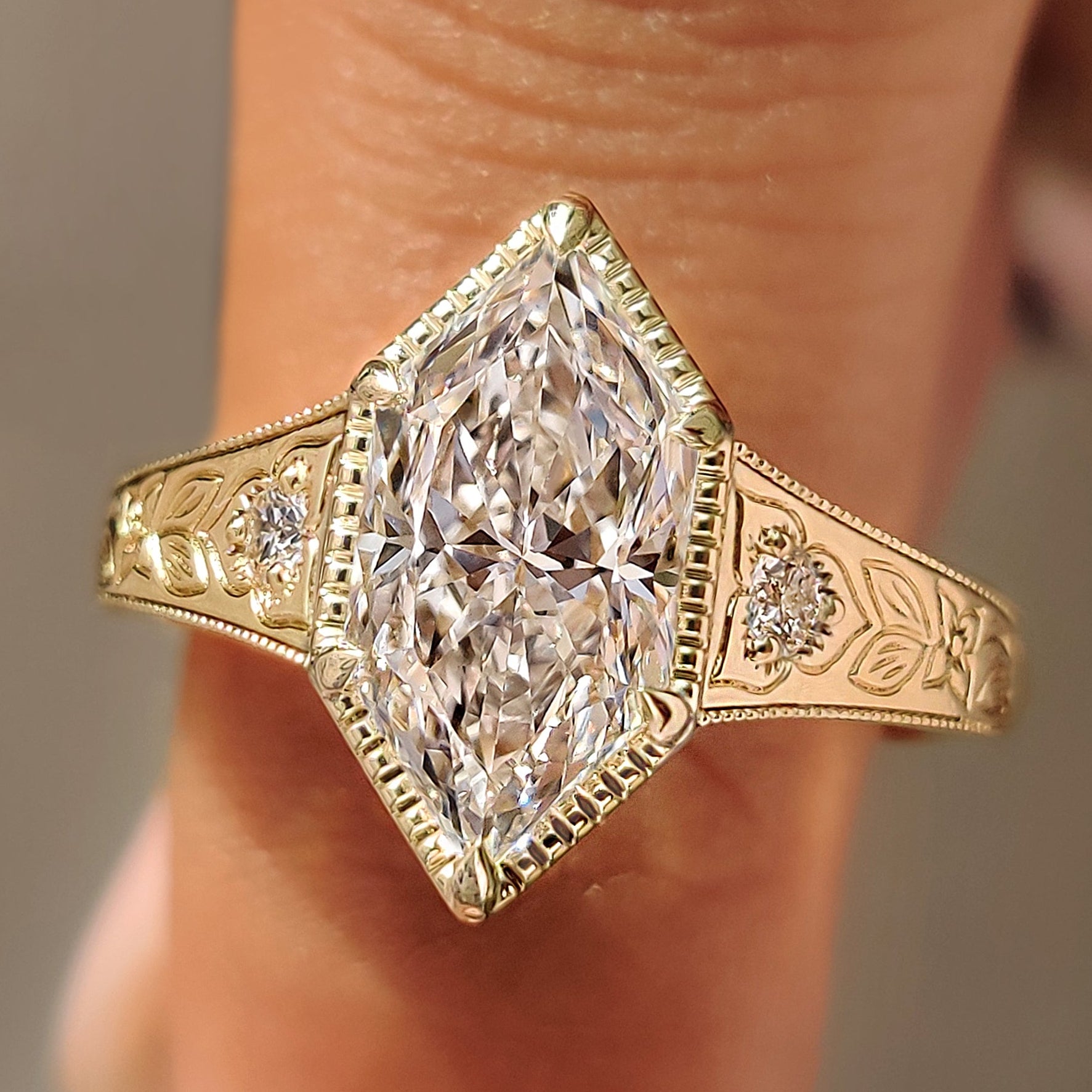 Dutch marquise three stone ring with round diamond side stones.

