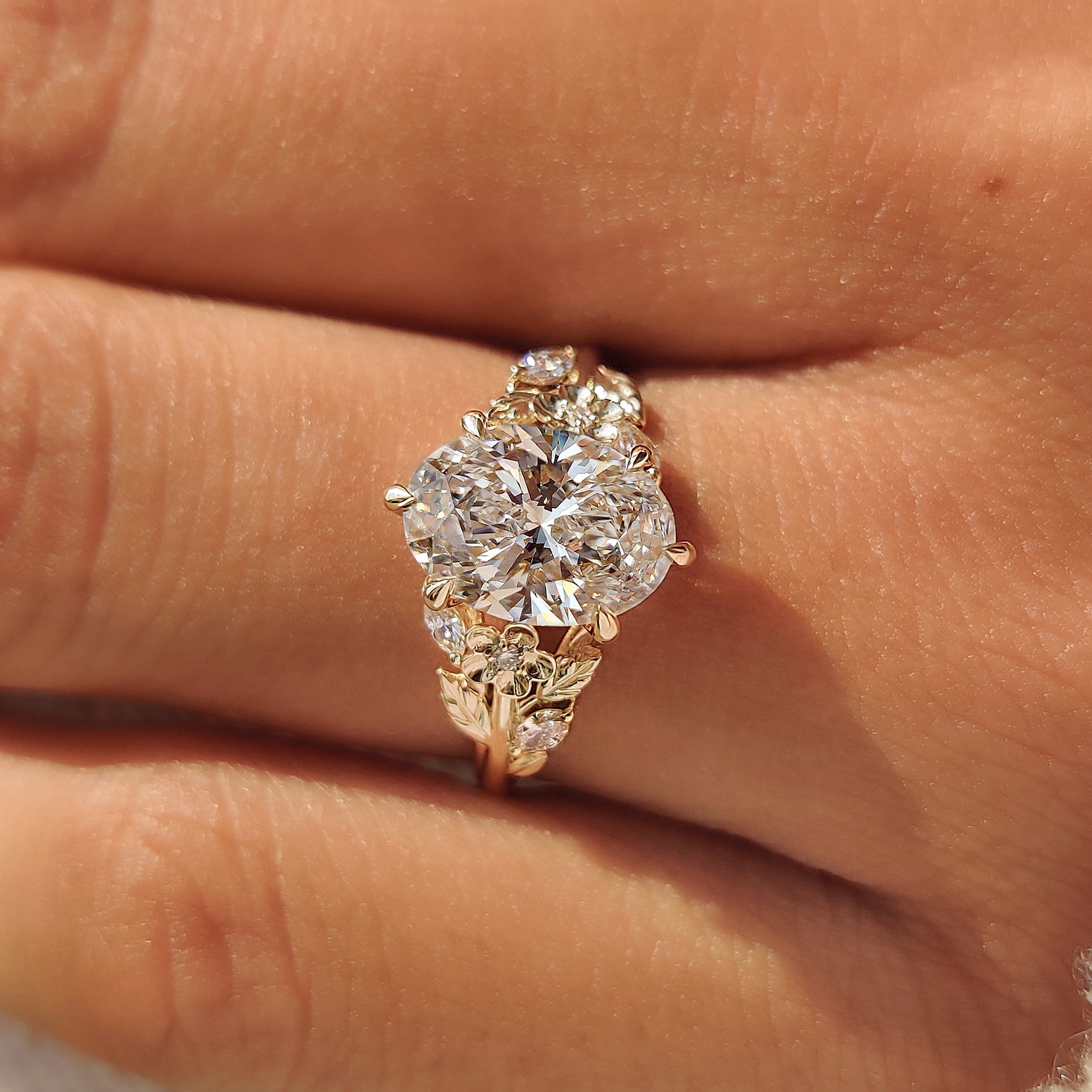 Marquise side stones surrounding an oval center diamond.
